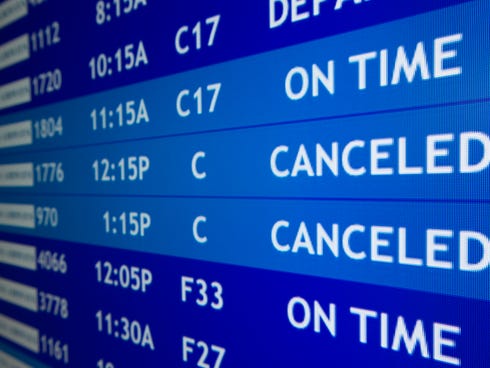 A flight status screen at Philadelphia International Airport as seen on Feb. 8, 2013.