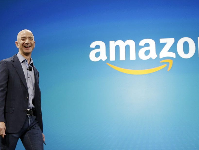 FILE - In this June 16, 2014 file photo, Amazon CEO Jeff Bezos walks on stage for the launch of the new Amazon Fire Phone, in Seattle. Amazon.com reports quarterly financial results on Thursday, Oct. 23, 2014. (AP Photo/Ted S. Warren, File) ORG XMIT: