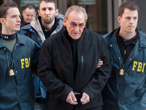 Vincent 'Vinny' Asaro (C), a reputed captain in the Bonanno crime family, is escorted by FBI agents out of a federal building in New York Jan. 23, 2014, following his arrest on charges of murder and taking part in the 1968 JFK Lufthansa heist.