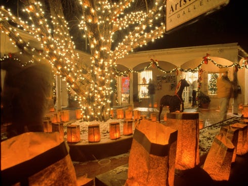 Santa Fe, New Mexico's saintly city, glows with lights and luminarias come Christmas Eve.