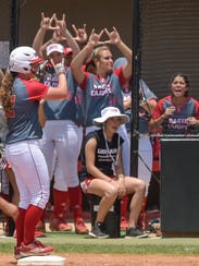 Shellie Landry stands on base as her teammates cheer