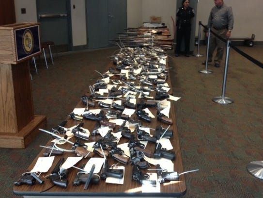 Rochester police display the guns collected at one