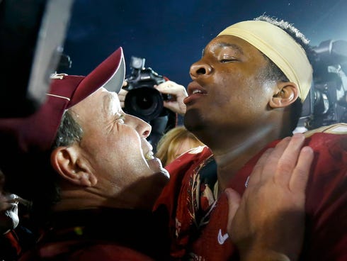 Florida Seminoles head coach Jimbo Fisher (L) celebrates with quarterback Jameis Winston after they defeated the Auburn Tigers to win the BCS Championship football game in Pasadena, Calif., on Jan. 6, 2014.