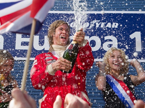 James Hunt (Chris Hemsworth) celebrates a racing victory in 'Rush.'