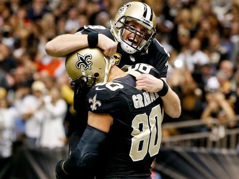 New Orleans Saints quarterback Drew Brees (9) celebrates with teammate tight end Jimmy Graham (80) following a touchdown during the fourth quarter of a game against the Tampa Bay Buccaneers at the Mercedes-Benz Superdome.