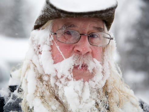 Lee Tuttle, 66, takes a break from blowing snow off of his driveway to pose for a portrait on Jan. 5, 2014 at his home on Miller Road in Flint, Mich.