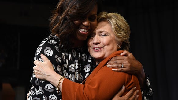 Michelle Obama embraces Hillary Clinton during a campaign