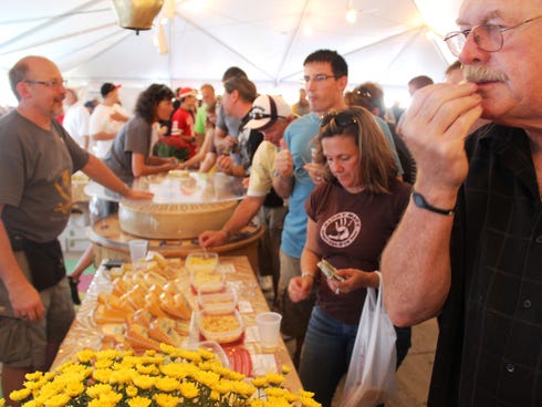 Wisconsin Master Cheesemaker Bruce Workman of Edelweiss Creamery serves samples.