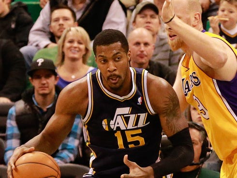 Dec 27, 2013; Salt Lake City, UT, USA; Utah Jazz power forward Derrick Favors (15) is guarded by Los Angeles Lakers center Chris Kaman (9) during the first quarter at EnergySolutions Arena. Mandatory Credit: Chris Nicoll-USA TODAY Sports