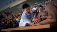 A boy arm wrestles with former NFL player Bob "The Beast" Sapp during a wrestling goodwill tour on Aug. 29 in Pyongyang.