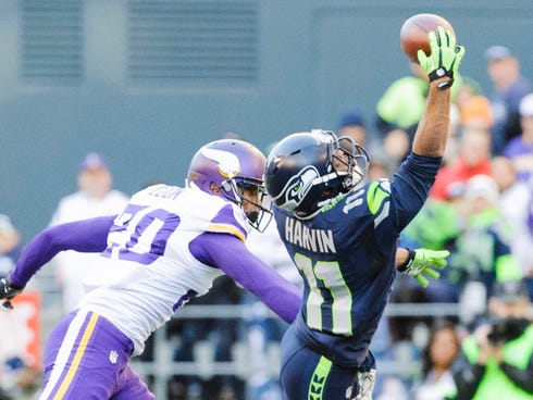 Seattle Seahawks wide receiver Percy Harvin (11) catches a pass over Minnesota Vikings cornerback Chris Cook (20) during the first half of their Nov. 17 game, Harvin's only action of the season because of injuries.