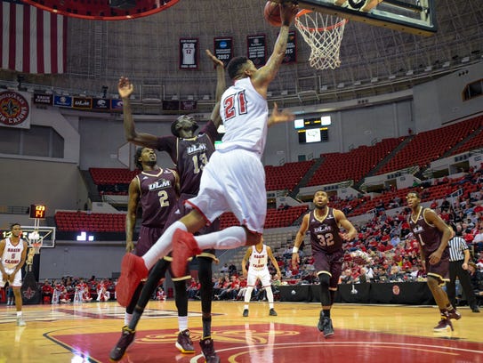 Shawn Long taking the ball to the basket as UL basketball