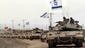 Israeli tanks drive near the border between Israel and Gaza as troops pull out of Gaza.