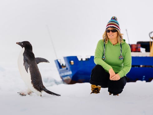 Barbara Tucker, a passenger on the MV Akademik Shokalskiy, watches a penguin on the ice off east Antarctica on Dec. 29.