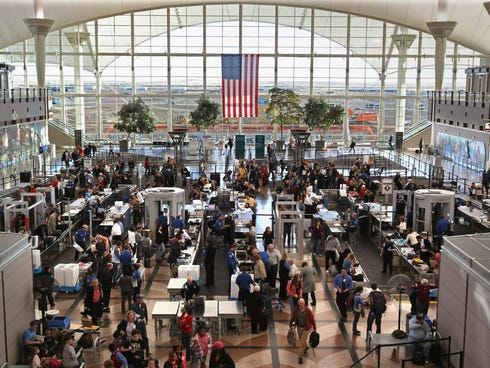 Passengers move through a main security checkpoint at the Denver International Airport.