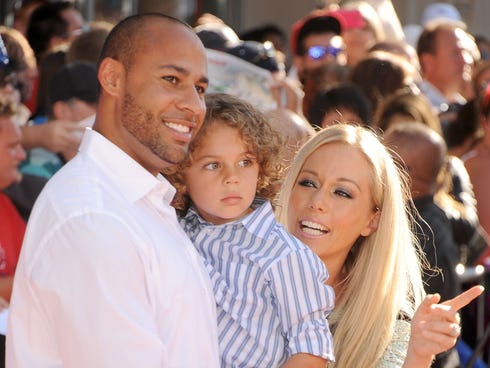 Hank Baskett, son Hank and TV personality Kendra Wilkinson arrive at the Los Angeles premiere of 'Planes' at the El Capitan Theatre on Aug. 5, 2013 in Hollywood.