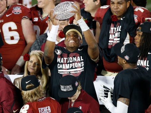 Florida State quarterback Jameis Winston the BCS championship trophy after beating Auburn to win the national title.