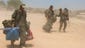 Israeli soldiers from a tank unit depart a staging area.