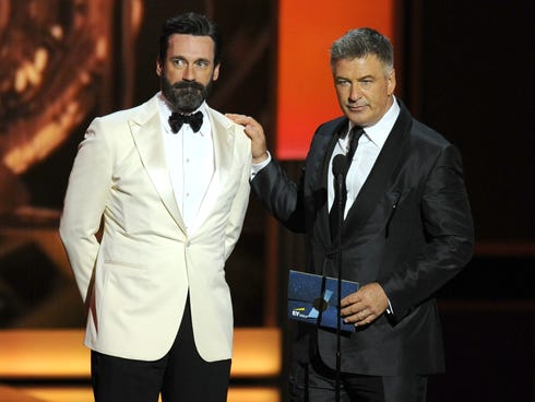 Jon Hamm, left, and Alec Baldwin present the award for outstanding lead actress in a comedy series on stage at the 65th Primetime Emmy Awards at Nokia Theater on Sept. 22, 2013, in Los Angeles.