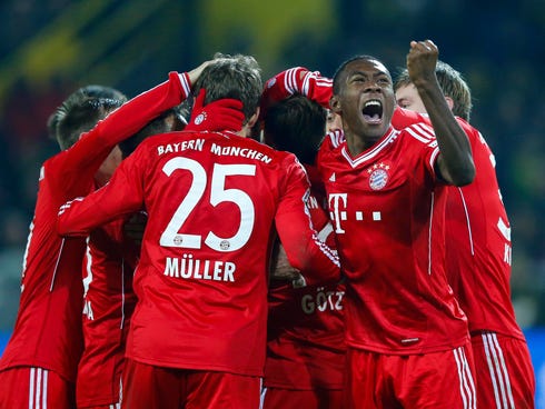 Bayern Munich's David Alaba (R) reacts after Mario Goetze (covered) scored a goal against Borussia Dortmund during their German first division Bundesliga soccer match in Dortmund, November 23,  2013.                    REUTERS/Kai Pfaffenbach (GERMAN