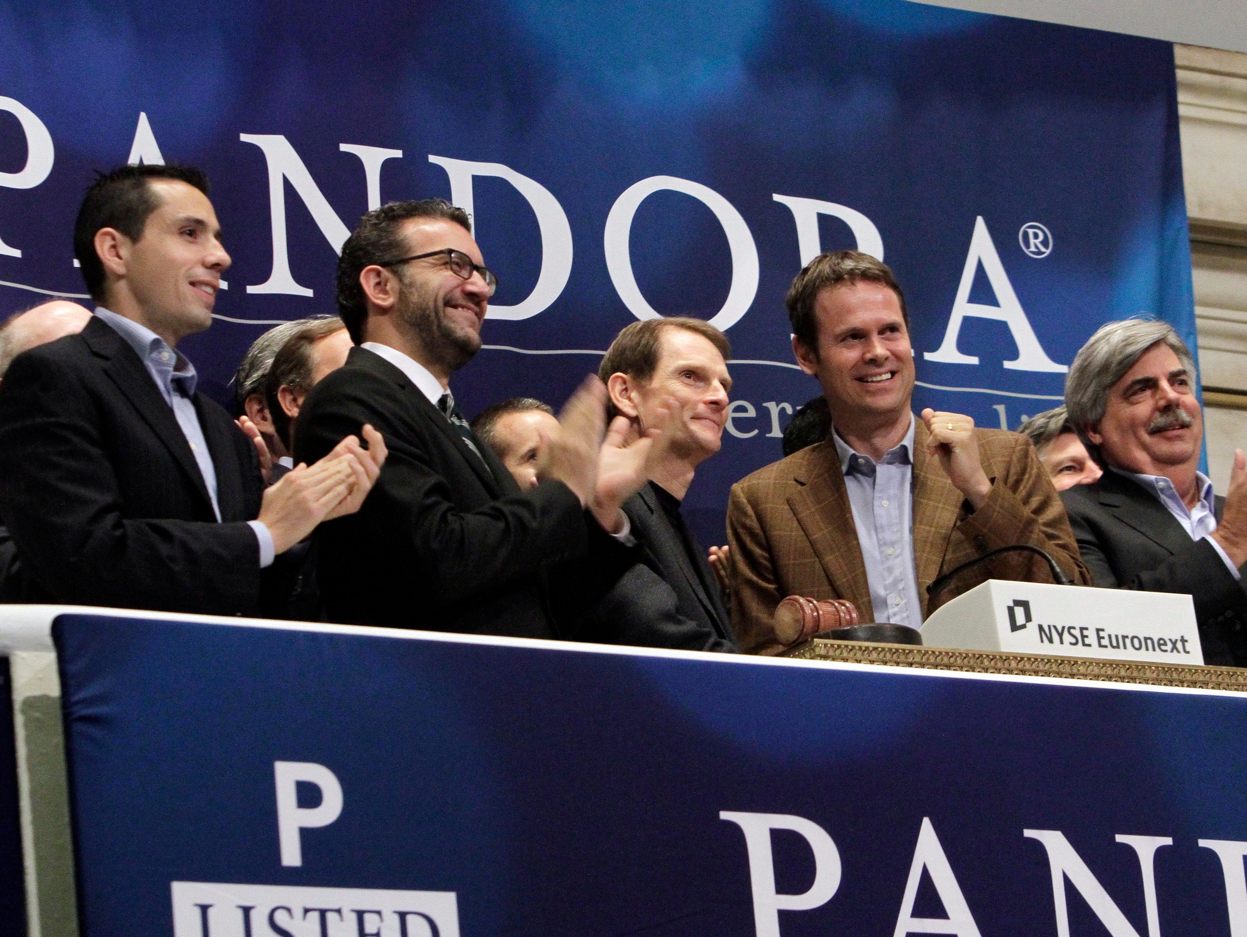 Joe Kennedy, third from left, CEO & President, and Tim Westergren, fourth from left, Chief Strategy Officer & Founder, of Pandora internet radio, ring the NYSE opening bell to celebrate their company's IPO in 2011. The surge of tech IPOs has raised q