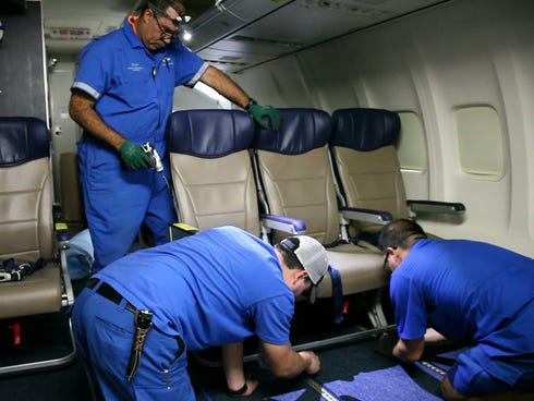 Southwest Airlines aircraft technicians install newer, skinnier seats on a 737 at the carrier's headquarters in Dallas on Sept. 23, 2013.