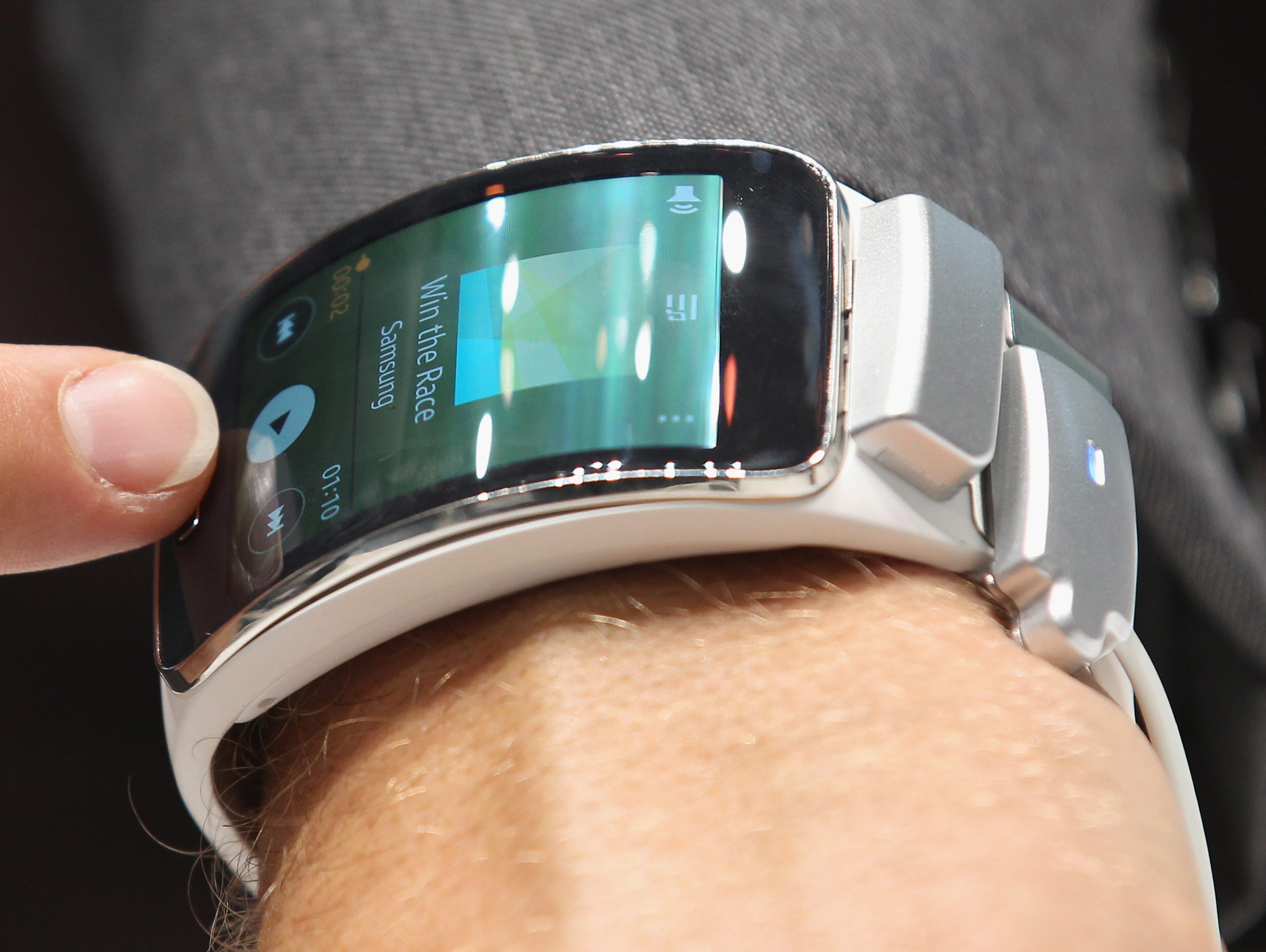 A visitor tries out a Samsung Gear S smart watch at the Samsung stand at the 2014 IFA home electronics and appliances trade fair on September 5, 2014 in Berlin, Germany.