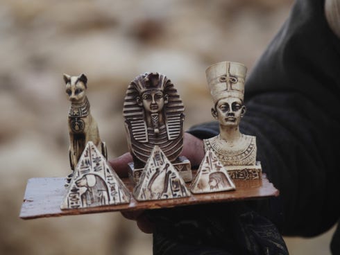 A man sells souvenirs at the historical site of the Giza Pyramids near Cairo, Egypt, on Dec. 13, 2013.