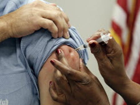 A patient in Jackson, Miss., gets a flu shot in October 2012.