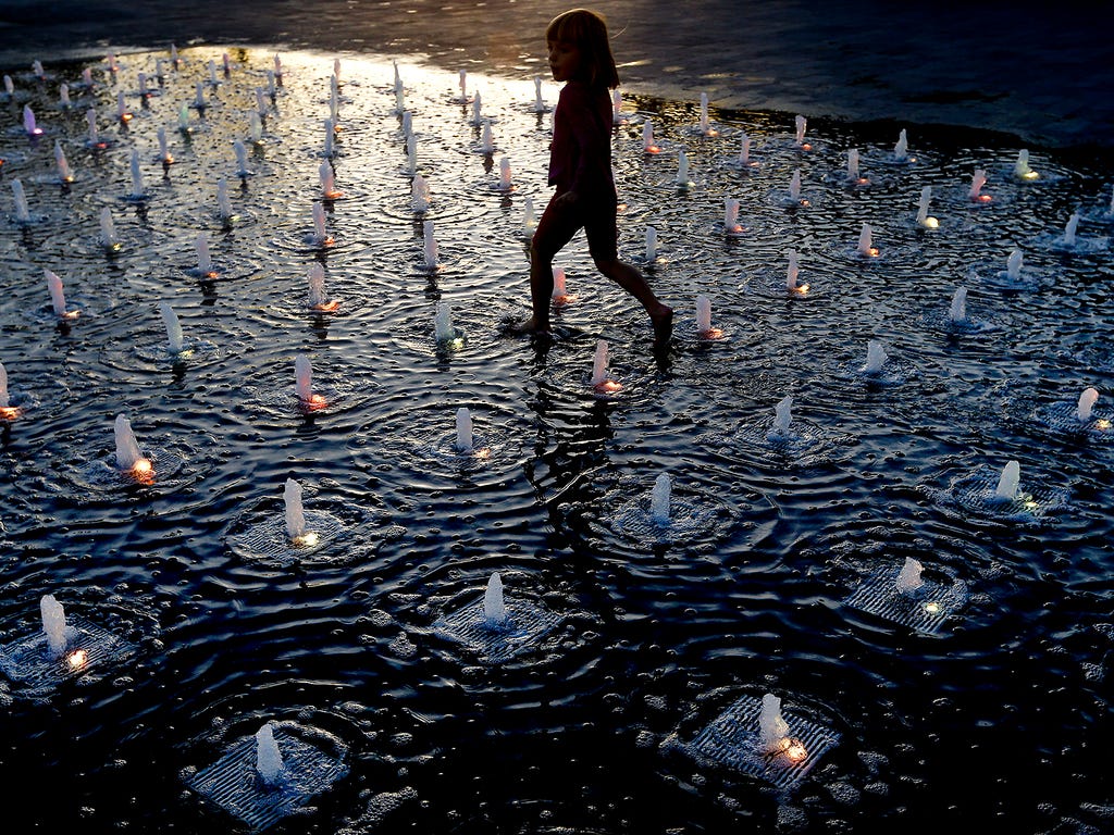 A child plays in a fountain on Oct. 31 in London.