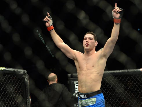 Chris Weidman reacts in the cage after defeating Anderson Silva (not pictured) in their UFC middleweight championship bout at the MGM Grand Garden Arena.