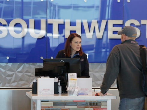 A Southwest Airlines agent helps a traveler at Love Field airport in Dallas the day before Thanksgiving. Southwest is hiring more flight attendants.