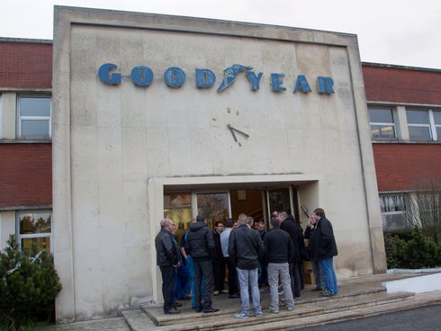 Workers of the Goodyear tire factory gather at an entrance to the plant in Amiens, northern France on Jan. 6, 2014.