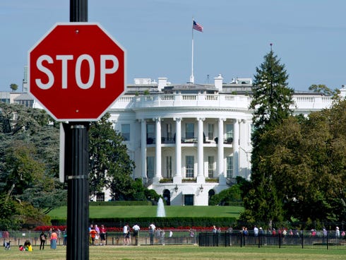 The White House is seen behind a stop sign in Washington, D.C., on Tuesday.