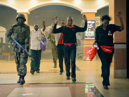 Civilians who had been hiding inside the Westgate Mall in Nairobi during the standoff exit the scene Sept, 21.  The extremist group Al-Shabab live-tweeted about this mall siege in Kenya.