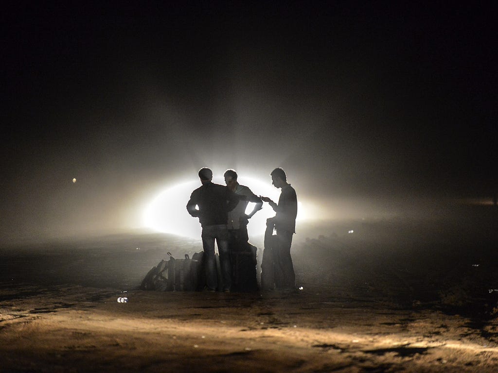 Kurdish refugees from Syria wait after crossing the border into Turkey on Sept. 30 in Suruc in the Sanliurfa province.