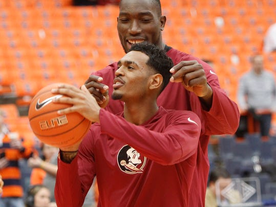 Florida State's Michael Ojo, right, distracts teammate Xavier Rathan-Mayes, left, while shooting foul shots before an NCAA college basketball game in Syracuse, N.Y., Saturday, Jan. 28, 2017. (AP Photo/Nick Lisi)
