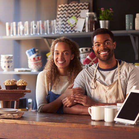 Couple standing behind bakery counter