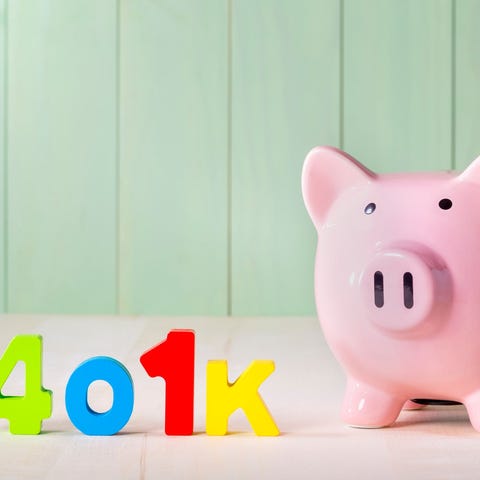 401(k) written in colorful letters next to a piggy