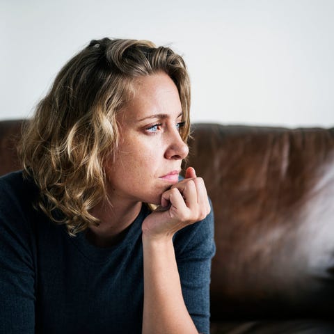 Woman thinking with her chin resting on her hand a