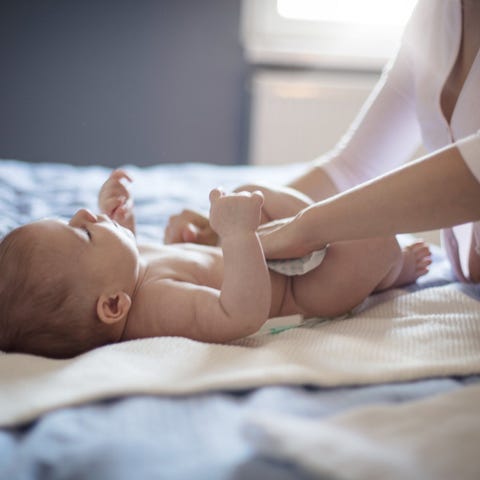 A baby having her diaper changed.