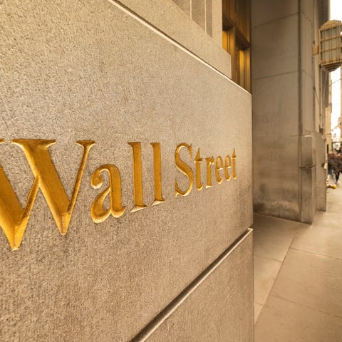 The words, Wall Street, engraved in gold on the si