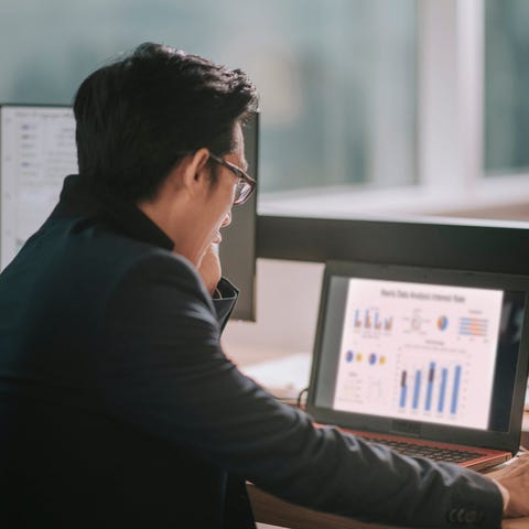 A businessperson works on a laptop.