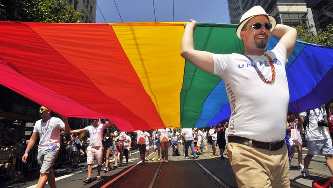 Gay Rights Supporters Carry A Rainbow Flag Along The Parade Route At