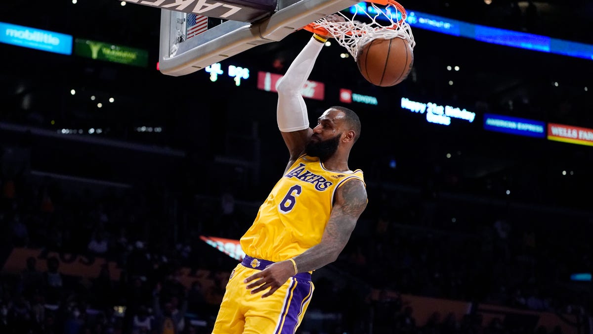 Los Angeles Lakers forward LeBron James dunks during the second half of the team's NBA basketball game against the Boston Celtics on Tuesday, Dec. 7, 2021, in Los Angeles. (AP Photo/Marcio Jose Sanchez)