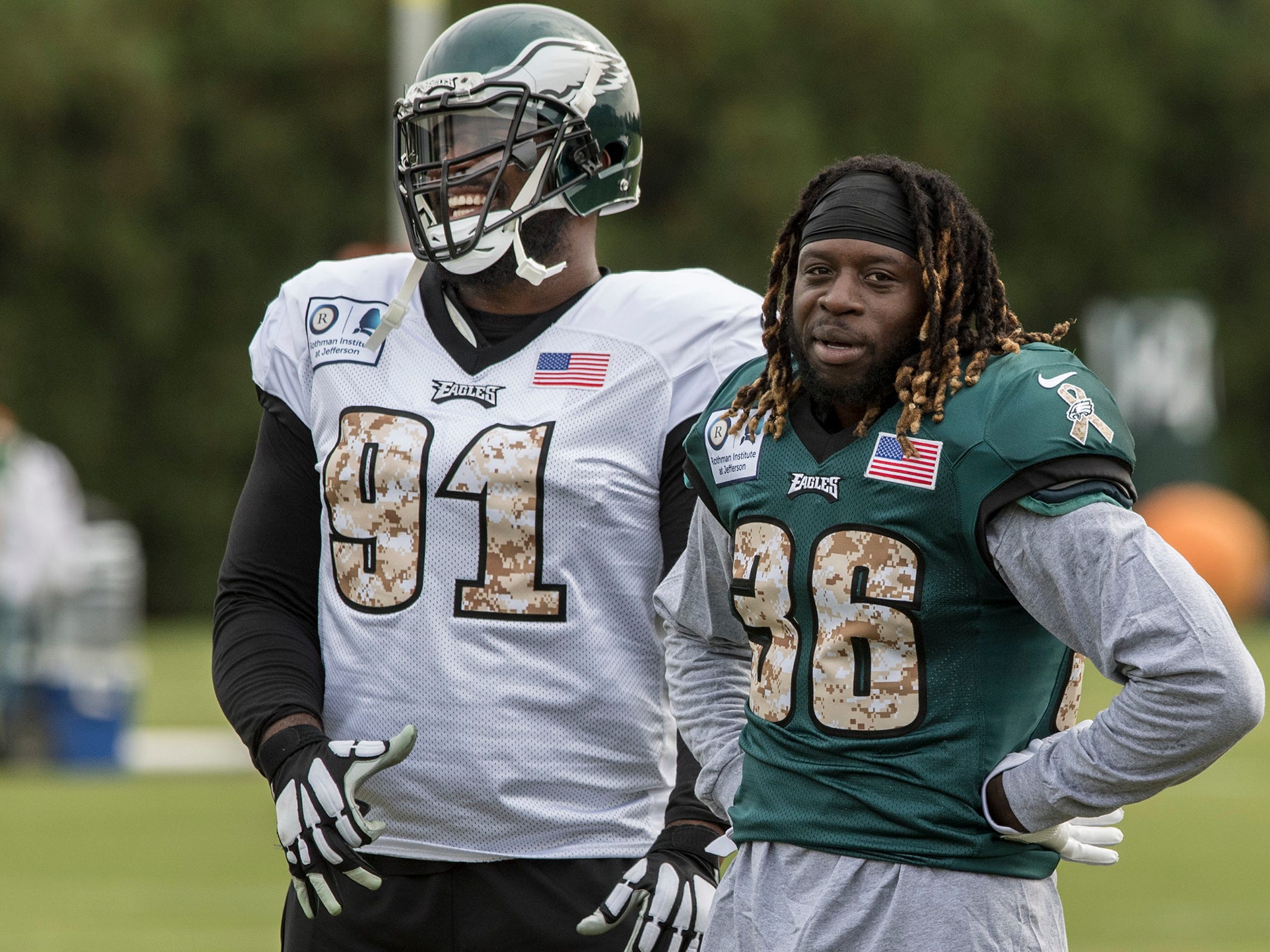 Philadelphia Eagles defensive tackle Fletcher Cox (91) has a laugh with newly acquired Eagles running back Jay Ajayi during his first practice with the Eagles, Wednesday, Nov. 1, 2017 in Philadelphia. Ajayi was acquired in a trade with the Miami Dolp