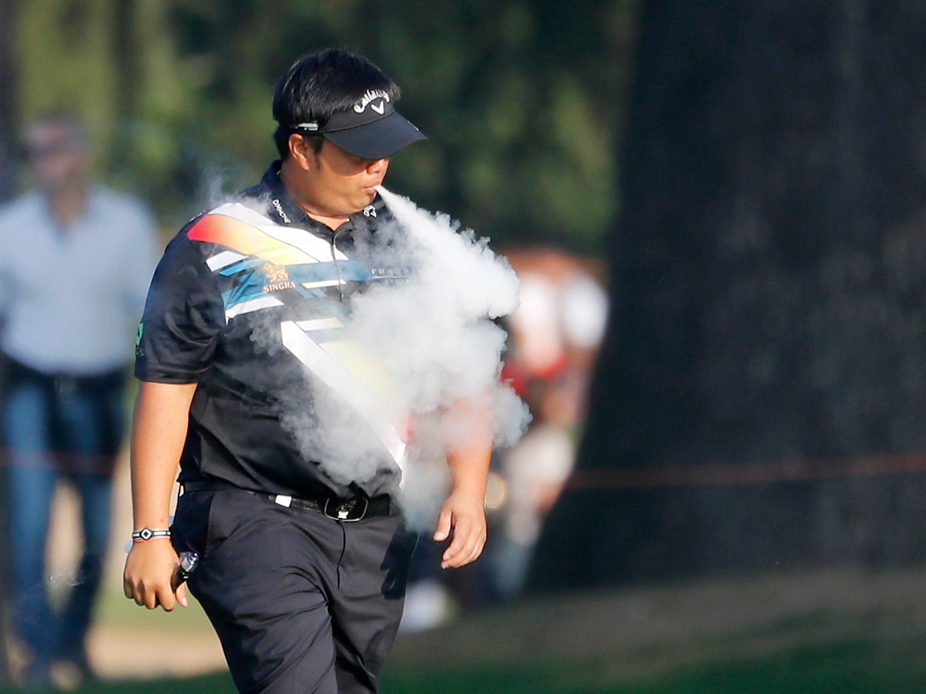 Kiradech Aphibarnrat, of Thailand, puffs a electronic cigarette during the 74th Italy Open Golf tournament in Monza, Italy, Saturday, Oct. 14, 2017. (AP Photo/Antonio Calanni)