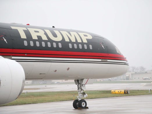 Trump, with mild regret, welcomes press aboard his jet