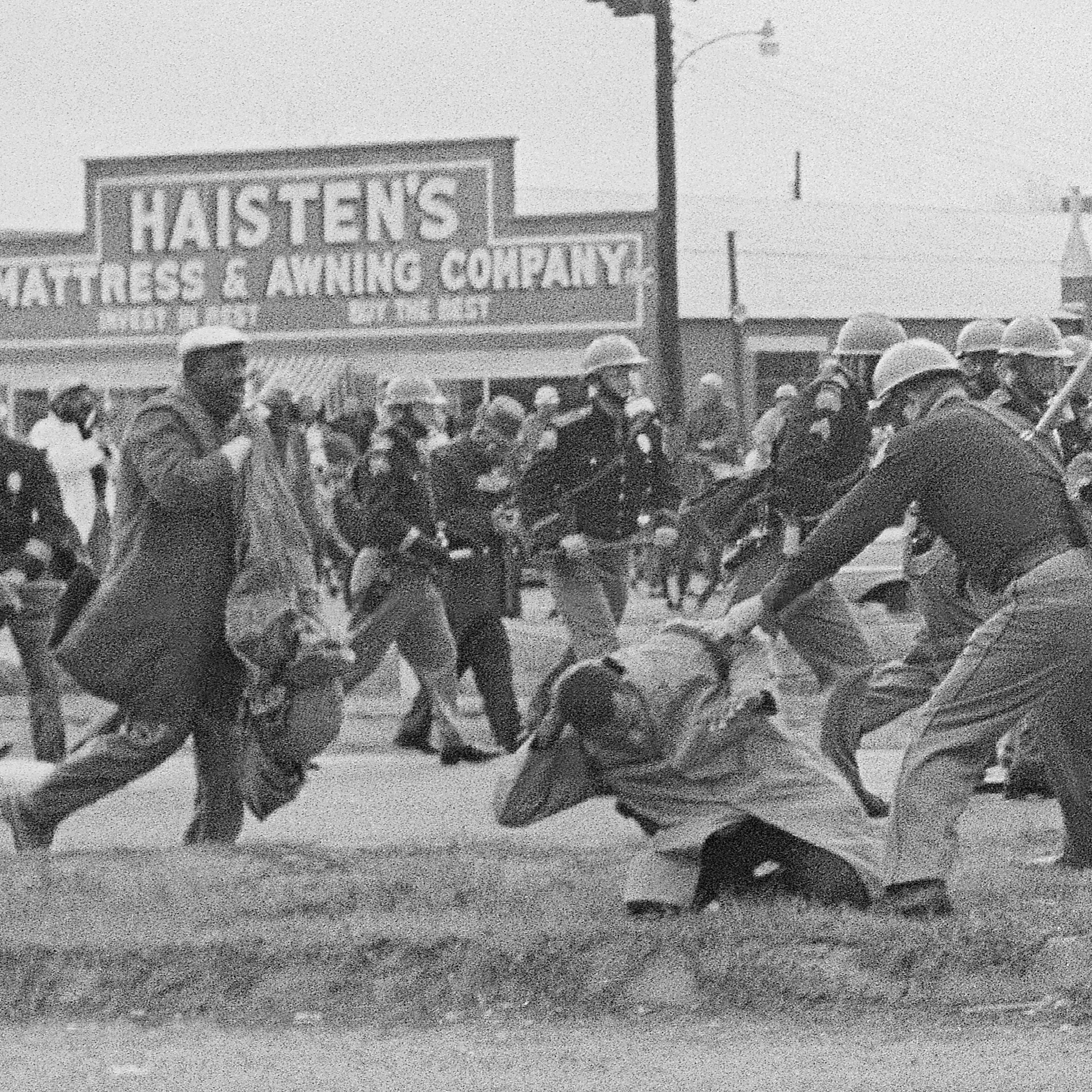 FILE - State troopers swinging billy clubs to break up a civil rights voting march in Selma, Ala., March 7, 1965. John Lewis and Hosea Williams lead approximately 600 people planning to march to Montgomery who are stopped as they try to cross the Edmund Pettus Bridge leading out of Selma. TV cameras broadcast the assault in what became known as "Bloody Sunday" with demonstrations across the country over the next two days supporting the marchers. (AP Photo/File)