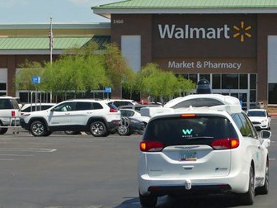 A Waymo car in a Walmart car park